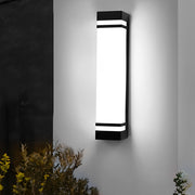 Vertical wall lighting mounted beside a door, offering a sleek and modern look to the exterior.