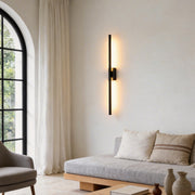 Vertical wall lights illuminating a modern living room with warm directional glow.