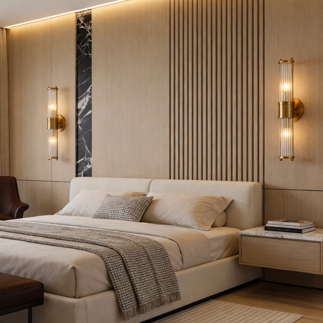 Vertical wall sconce lighting with a close-up of its cylindrical glass tubes in a bedroom.