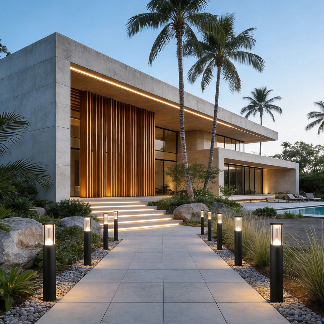 Contemporary villa garden pathway lined with minimalist black Landscape Bollard Lights and warm architectural lighting.
