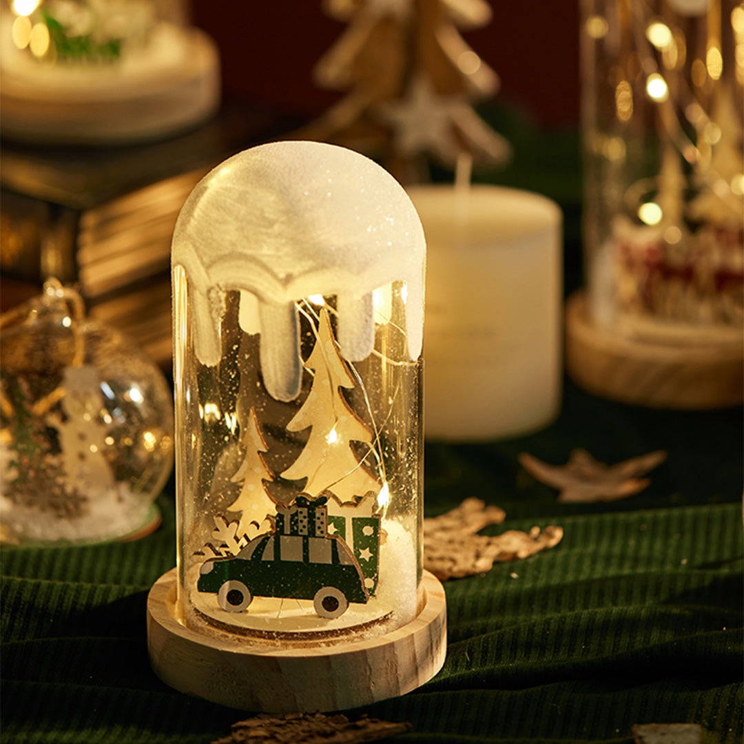 Two Christmas village dome lights with warm illumination, styled similarly to white glass table lamp decor.