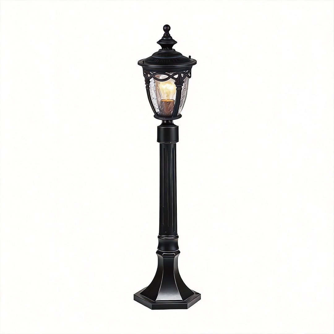A vintage style black outdoor light post standing tall isolated against a pure white background