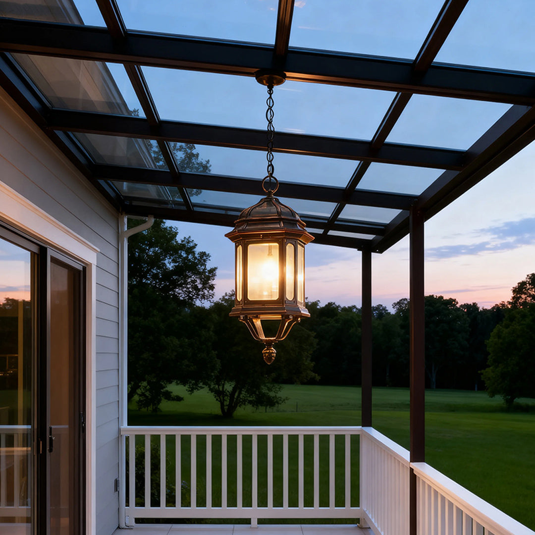 Vintage bollard LED light suspended from covered deck overhang illuminating outdoor seating at dusk