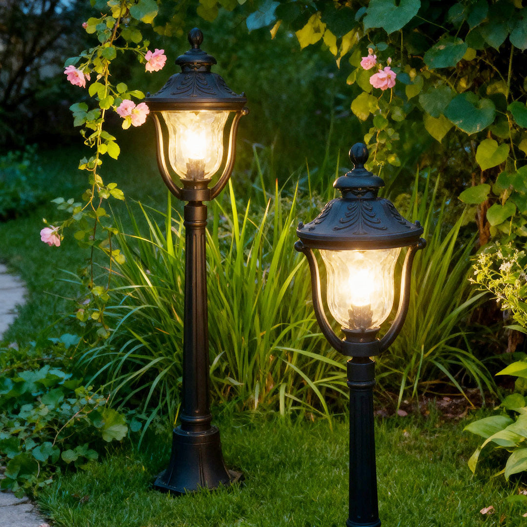 Vintage-style bollard post light in a lush garden, warm and inviting outdoor lighting