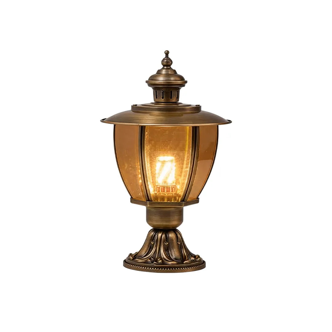 Vintage brass pillar lantern with clear glass shade warm glow and ornate base