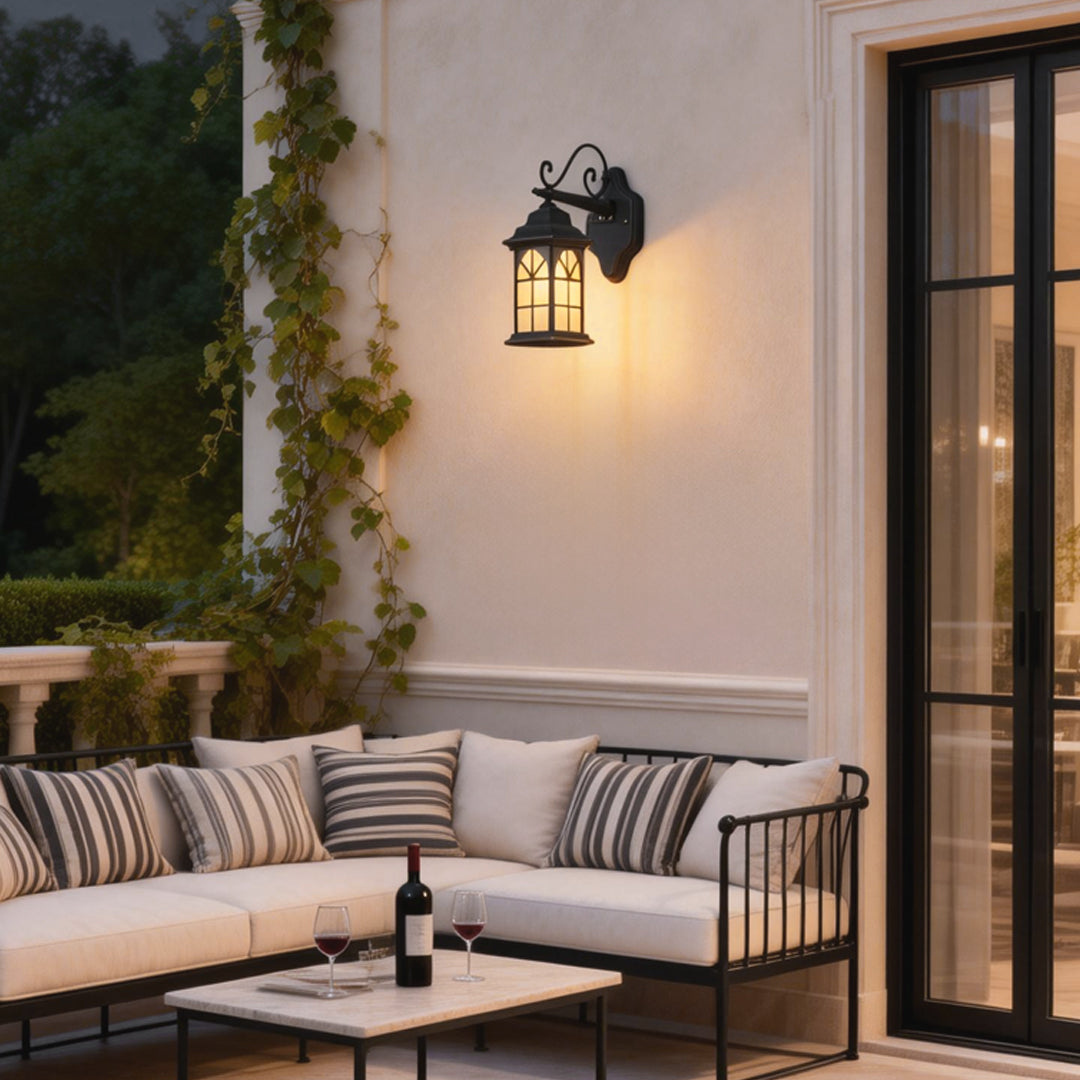 Vintage bronze classic porch light with decorative scroll arm and frosted glass panels for outdoor ambiance.