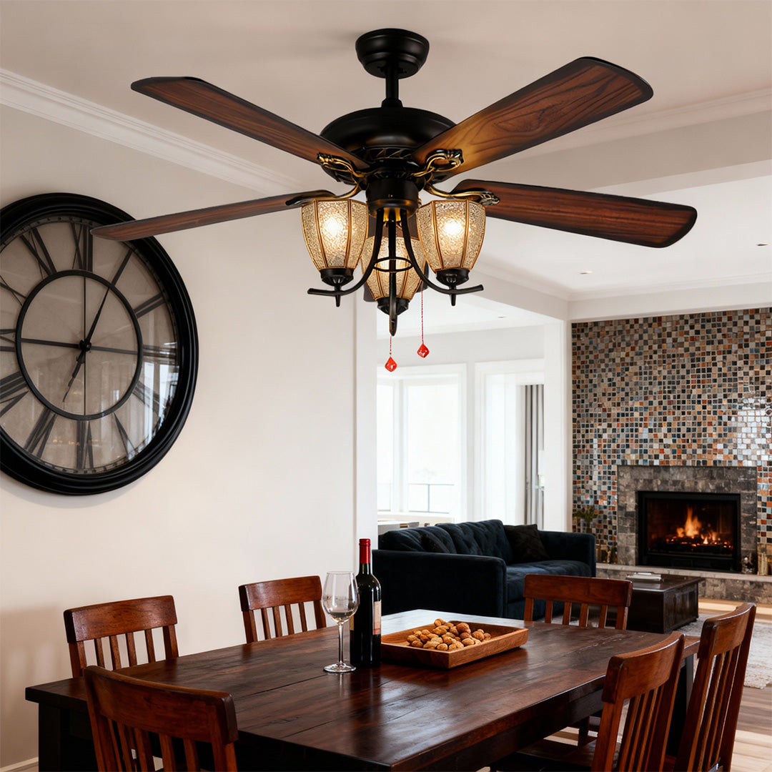 Vintage style ceiling fan with lights mounted in dining room with dark wood table and decorative wall clock.