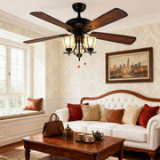 Vintage style ceiling fan with lights installed in bright living room with white sofa and exposed beam ceiling.