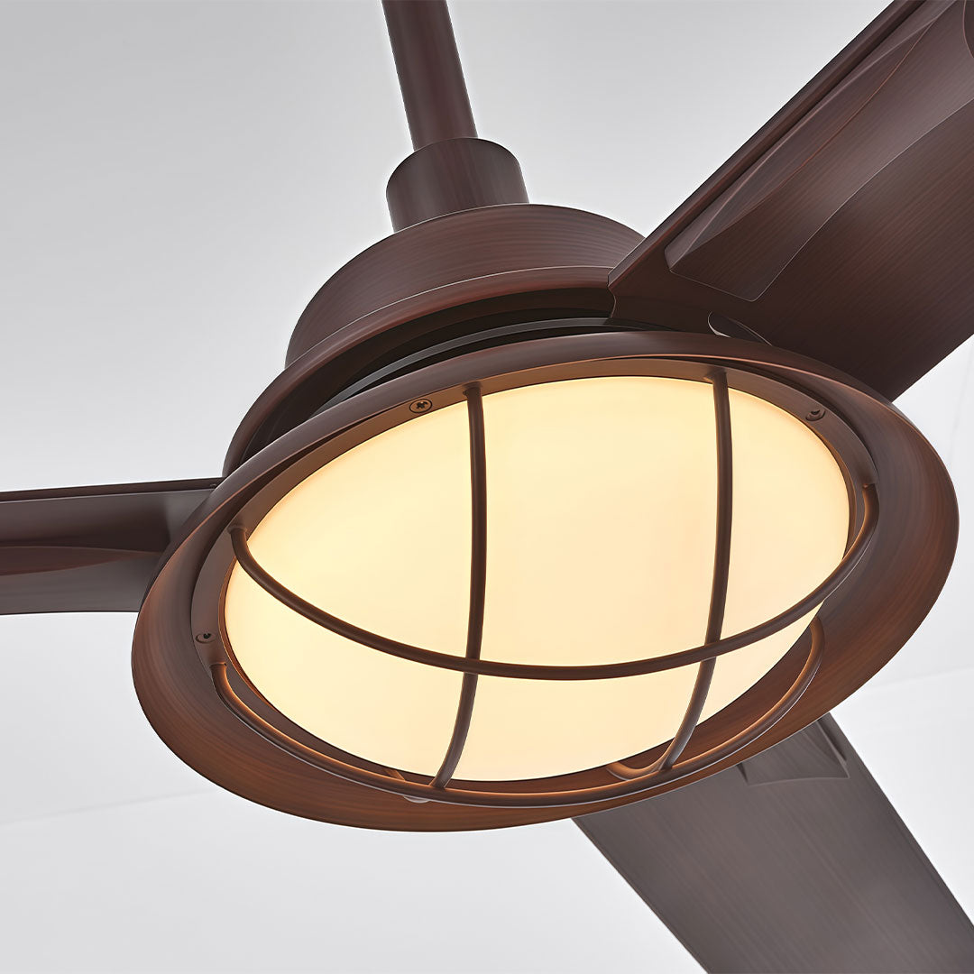 Close-up of vintage ceiling fans with lights featuring a caged bowl light and dark wood blades.