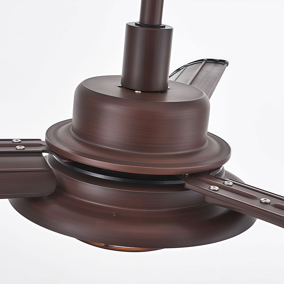 Close-up of vintage ceiling fans with lights showing the oil-rubbed bronze motor housing and blade arms.