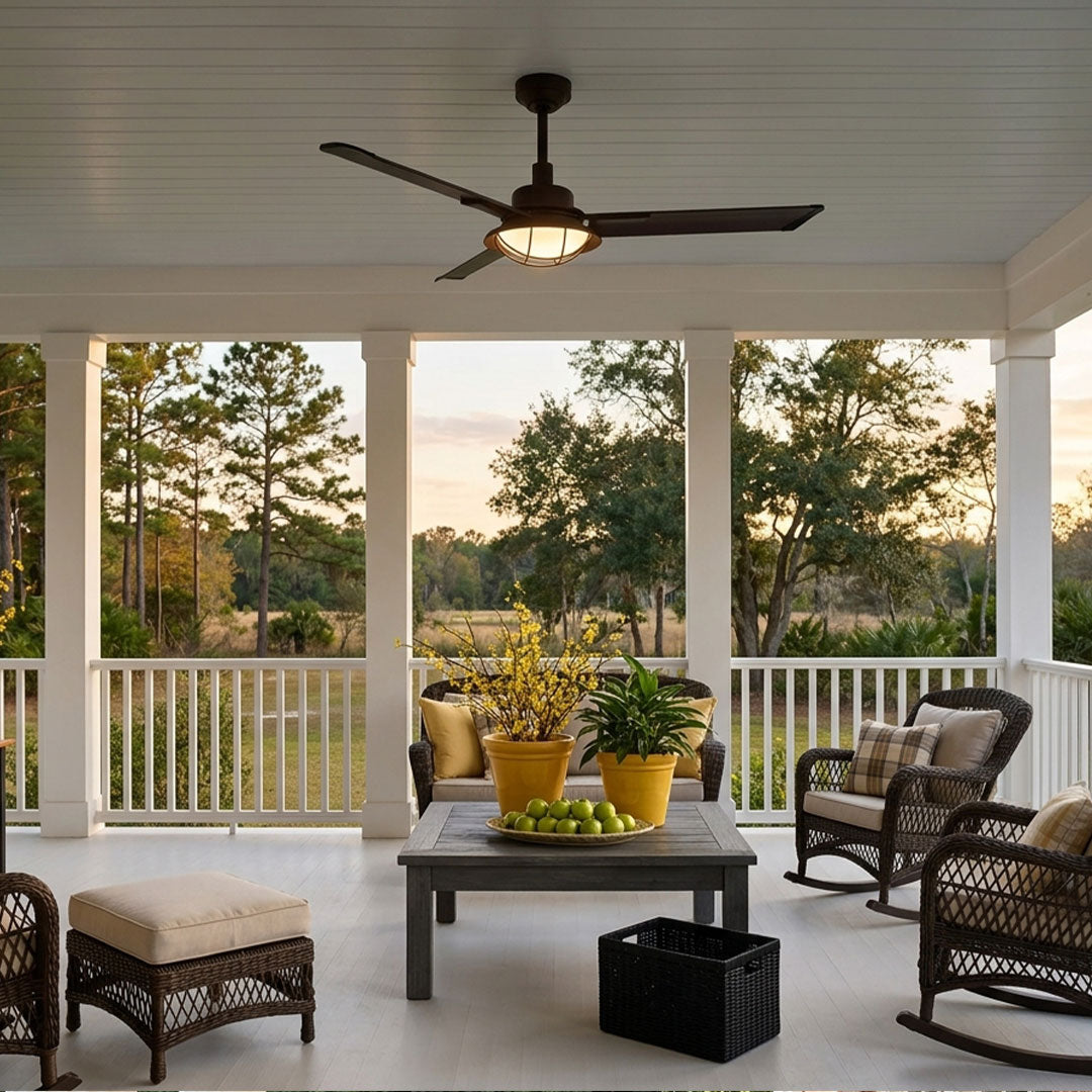 Vintage ceiling fans with lights above a screened porch seating area with a warm sunset view.