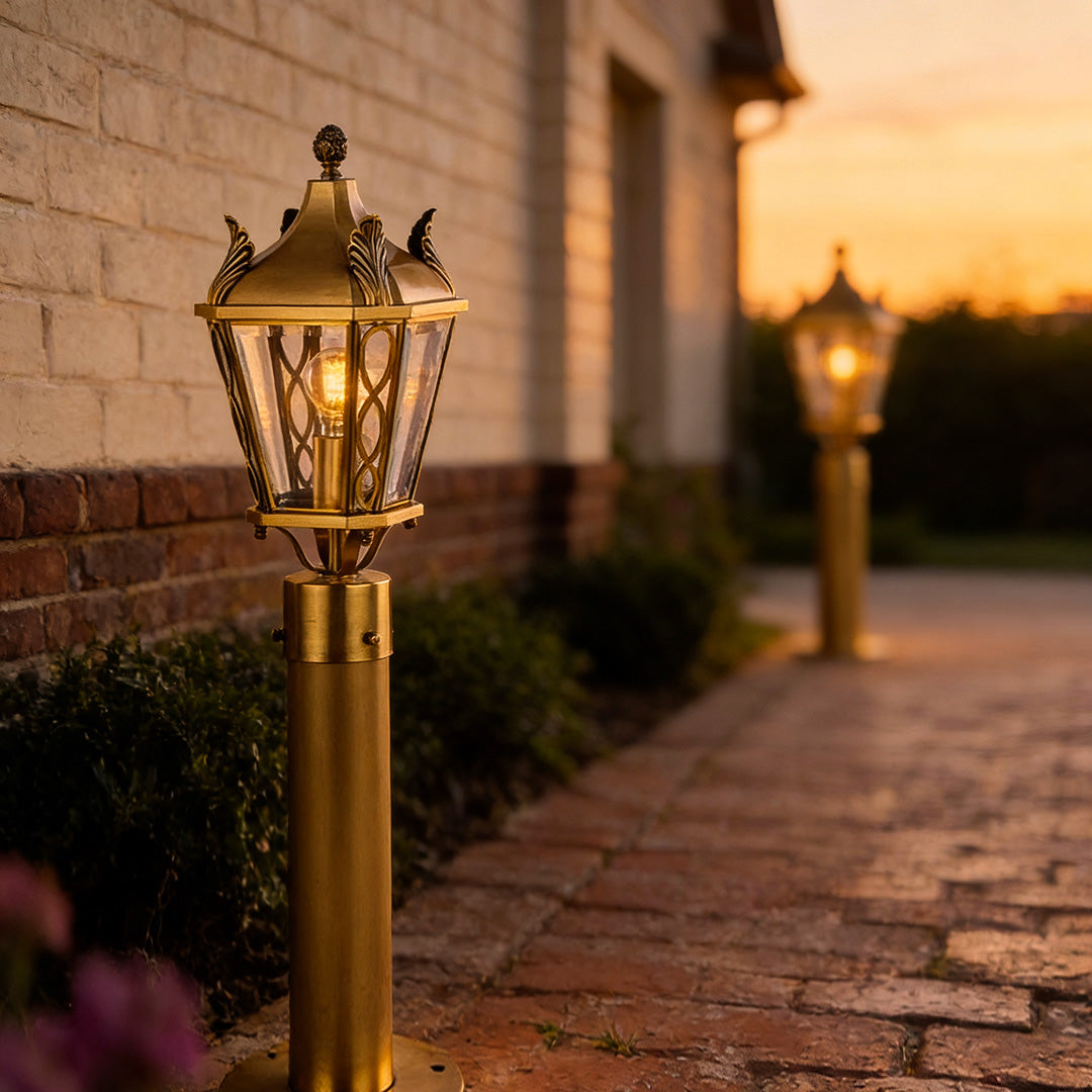 Vintage-inspired copper outdoor path lighting adding elegance to a brick-paved walkway during dusk hours.