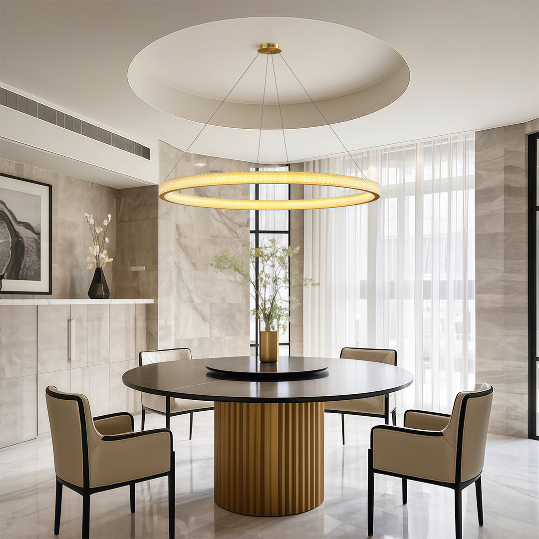 Modern luxury chandeliers above round table in bright dining room with fluted base
