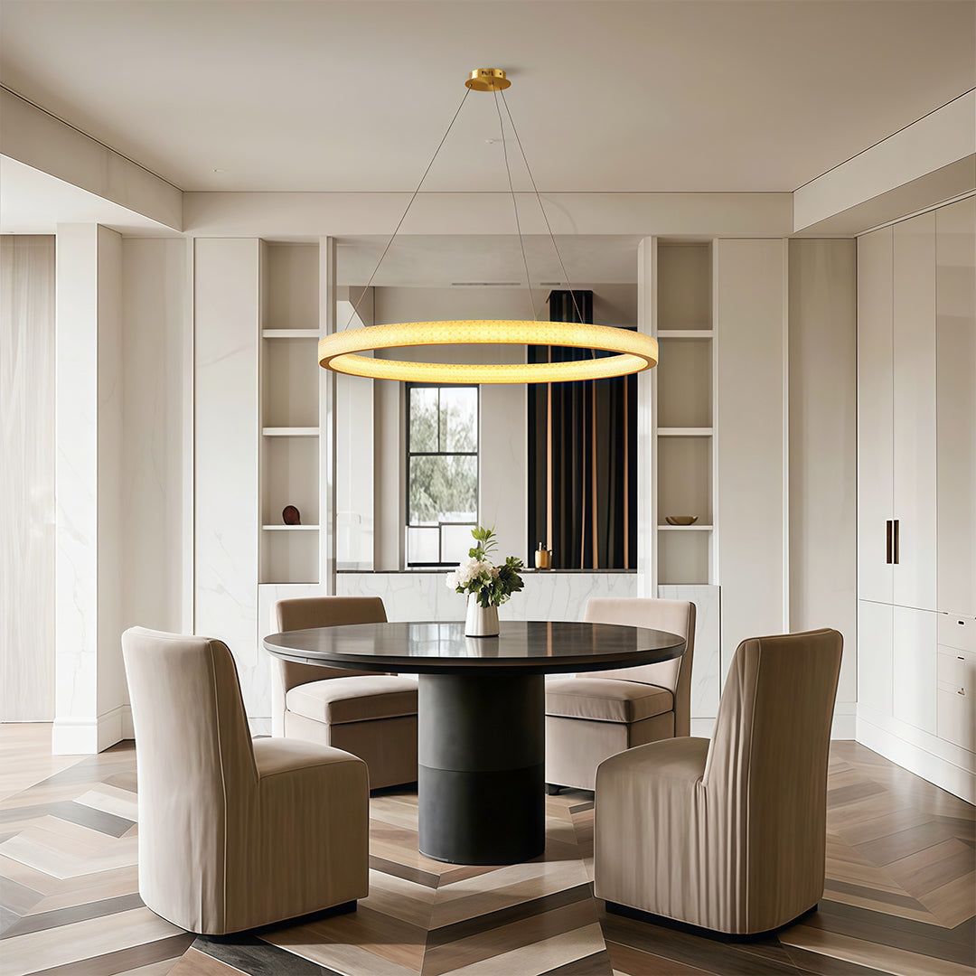 Vintage crystal chandeliers lighting bright dining space with round table and beige chairs