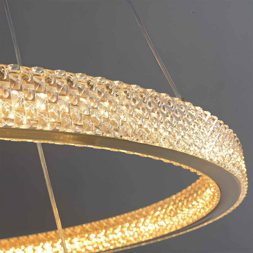 Modern luxury chandeliers close-up showcasing crystal-embedded brass ring detail