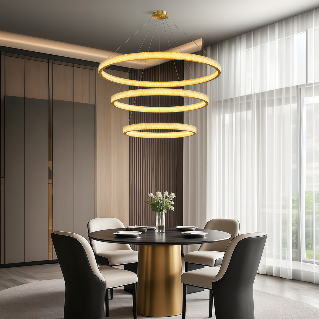 Vintage crystal chandeliers illuminating contemporary dining room with round table and black chairs