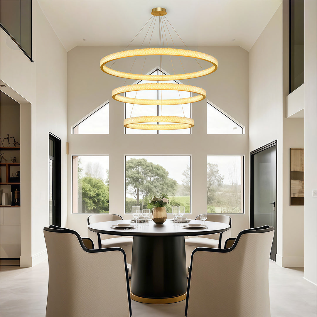 Modern luxury chandeliers illuminating elegant round dining table with upholstered seating