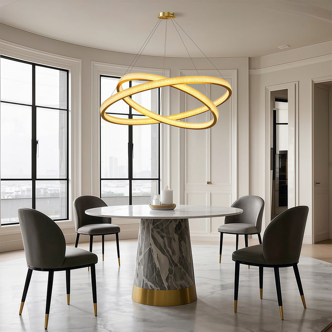 Vintage crystal chandeliers above marble dining table with modern black chairs
