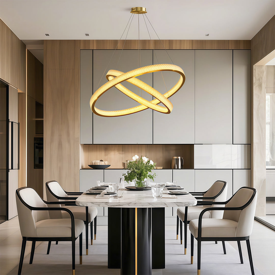 Modern luxury chandeliers above modern dining table in contemporary space with wood paneling