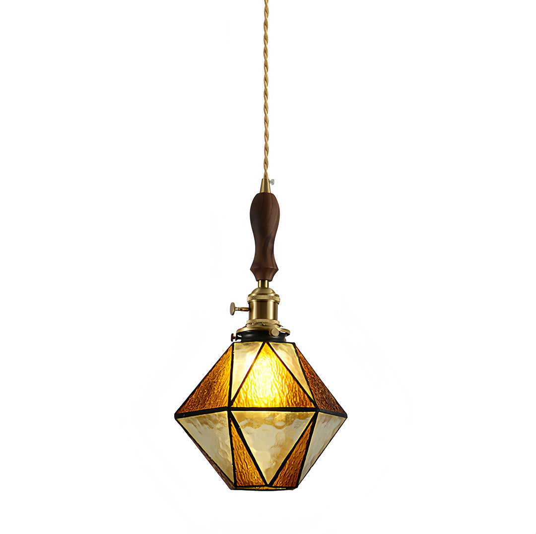 Vintage diamond-shaped pendant light with amber glass panels and decorative brass metalwork for warm illumination