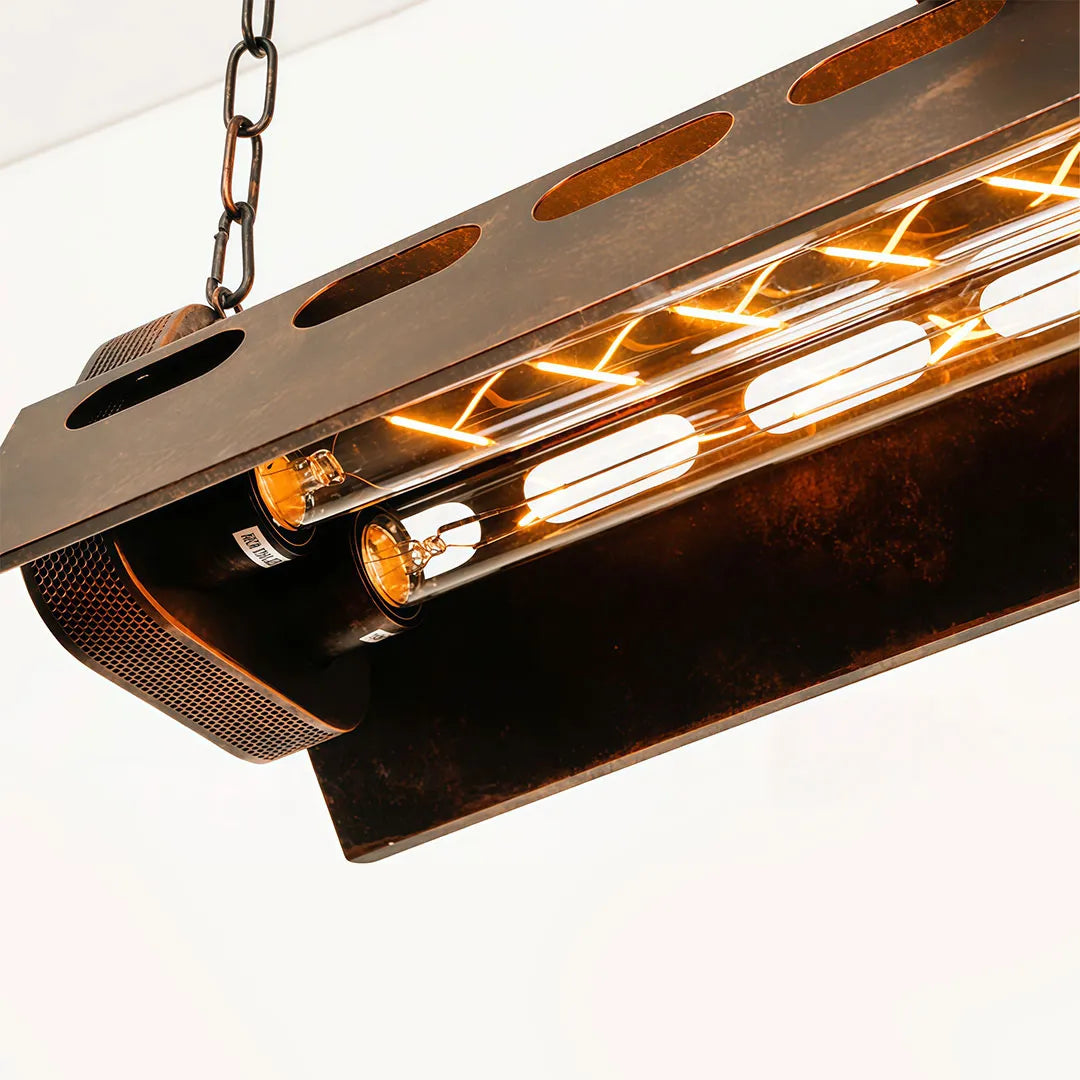 Close-up of vintage farmhouse chandelier showing the metal frame, exposed bulbs, and hanging chain.