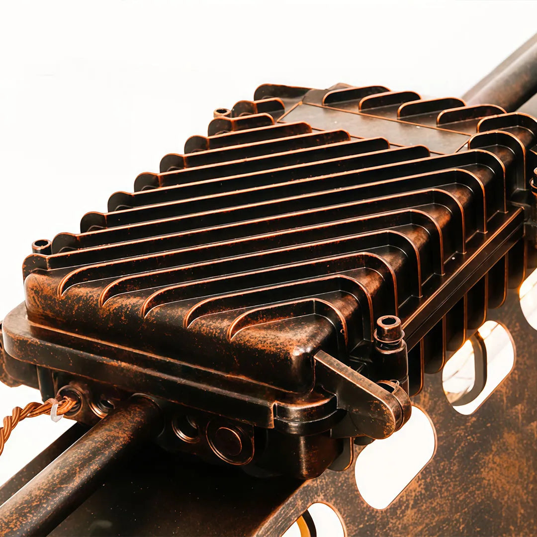 Close-up of vintage farmhouse chandelier highlighting the textured heat sink and aged metal finish.