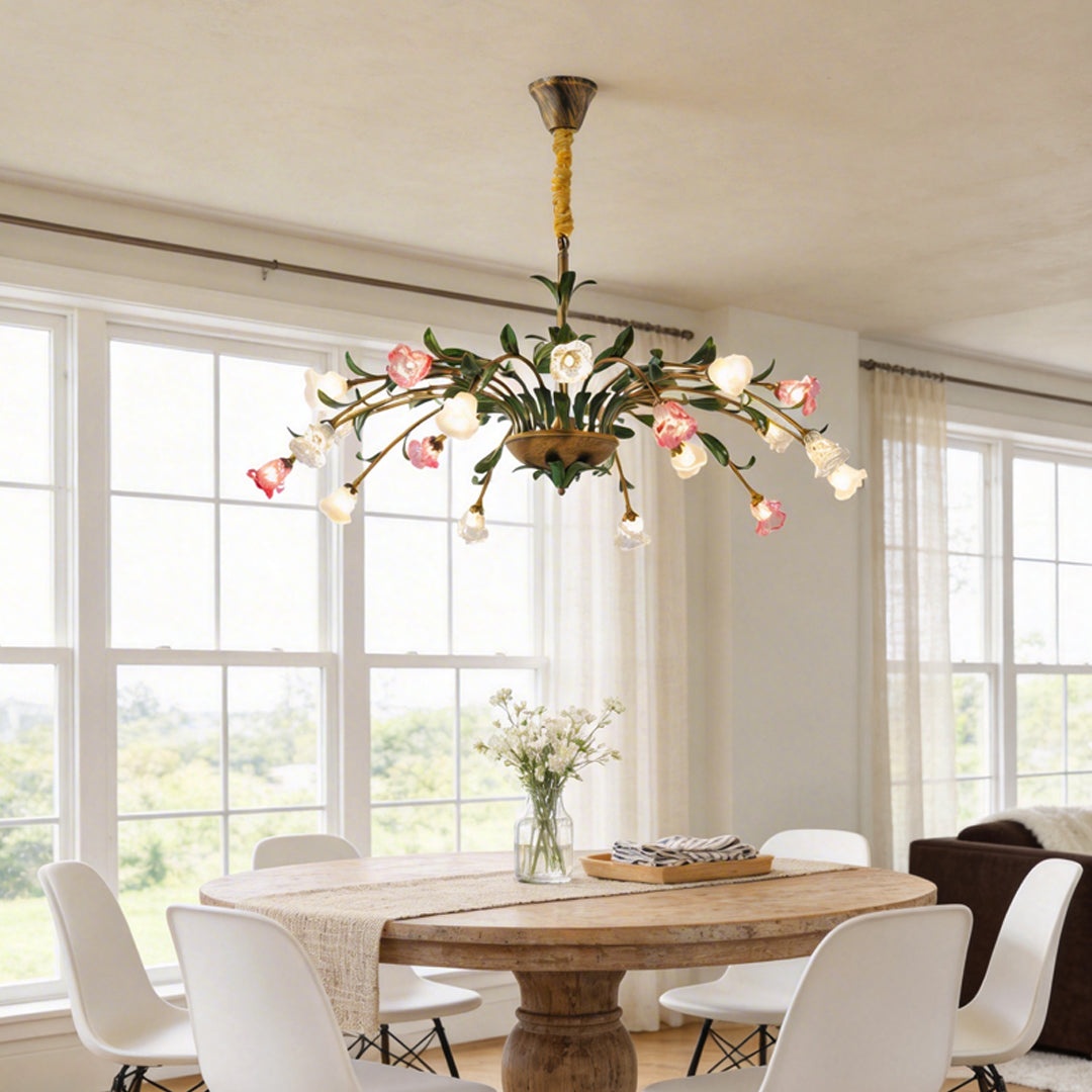 Vintage floral chandelier with pink and white flowers, illuminating a classic dining room.