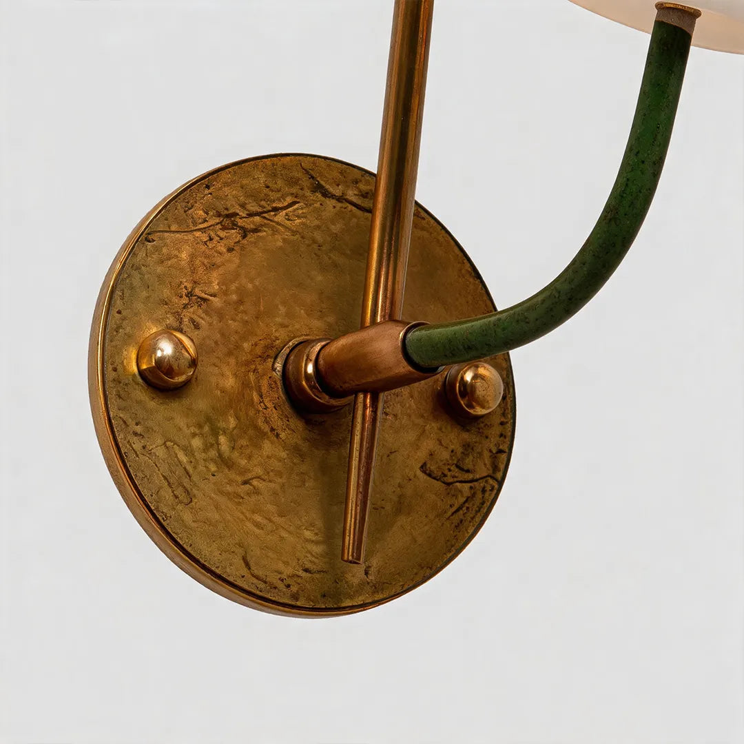 Vintage French wall lights close-up of the antique brass backplate, curved arm, and wall mounting hardware.