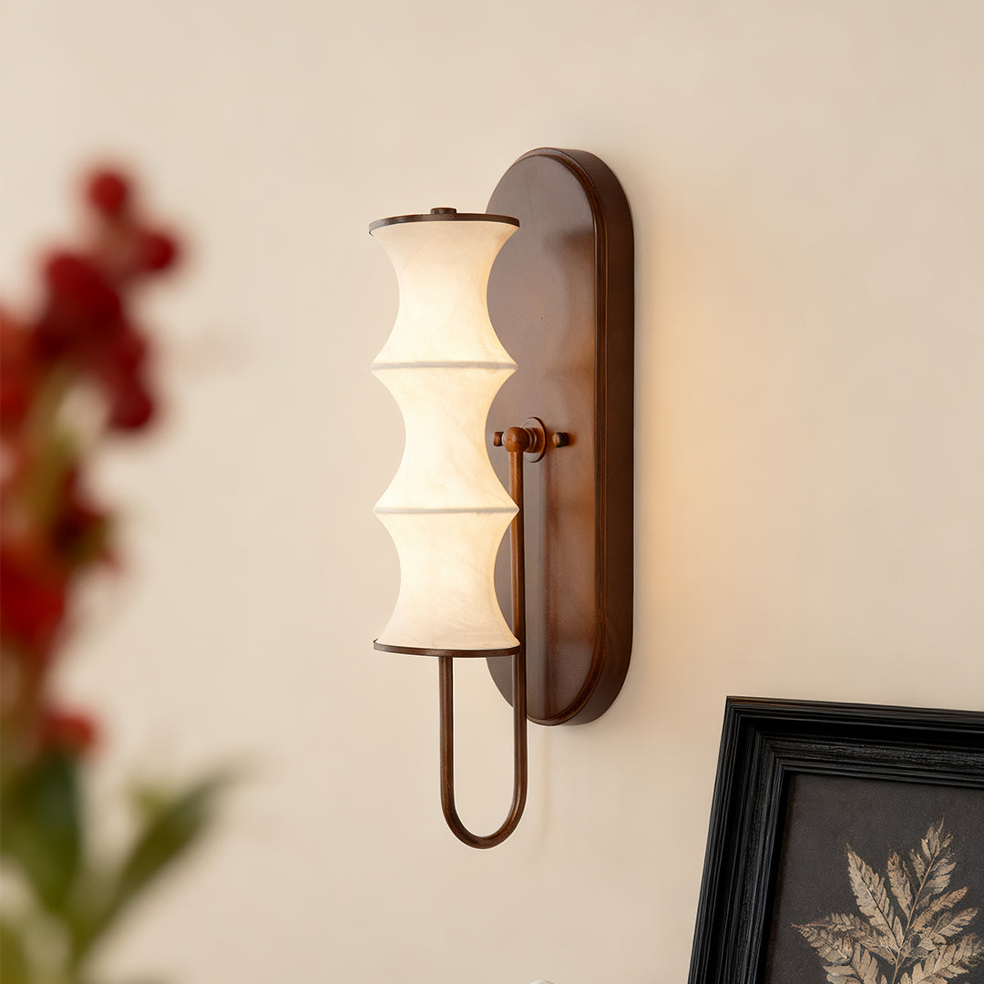 Stylish triple cylindrical vintage French wall lights with white glass shades in a cozy living room