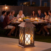 Vintage garden lanterns illuminating an outdoor dining table with warm light.