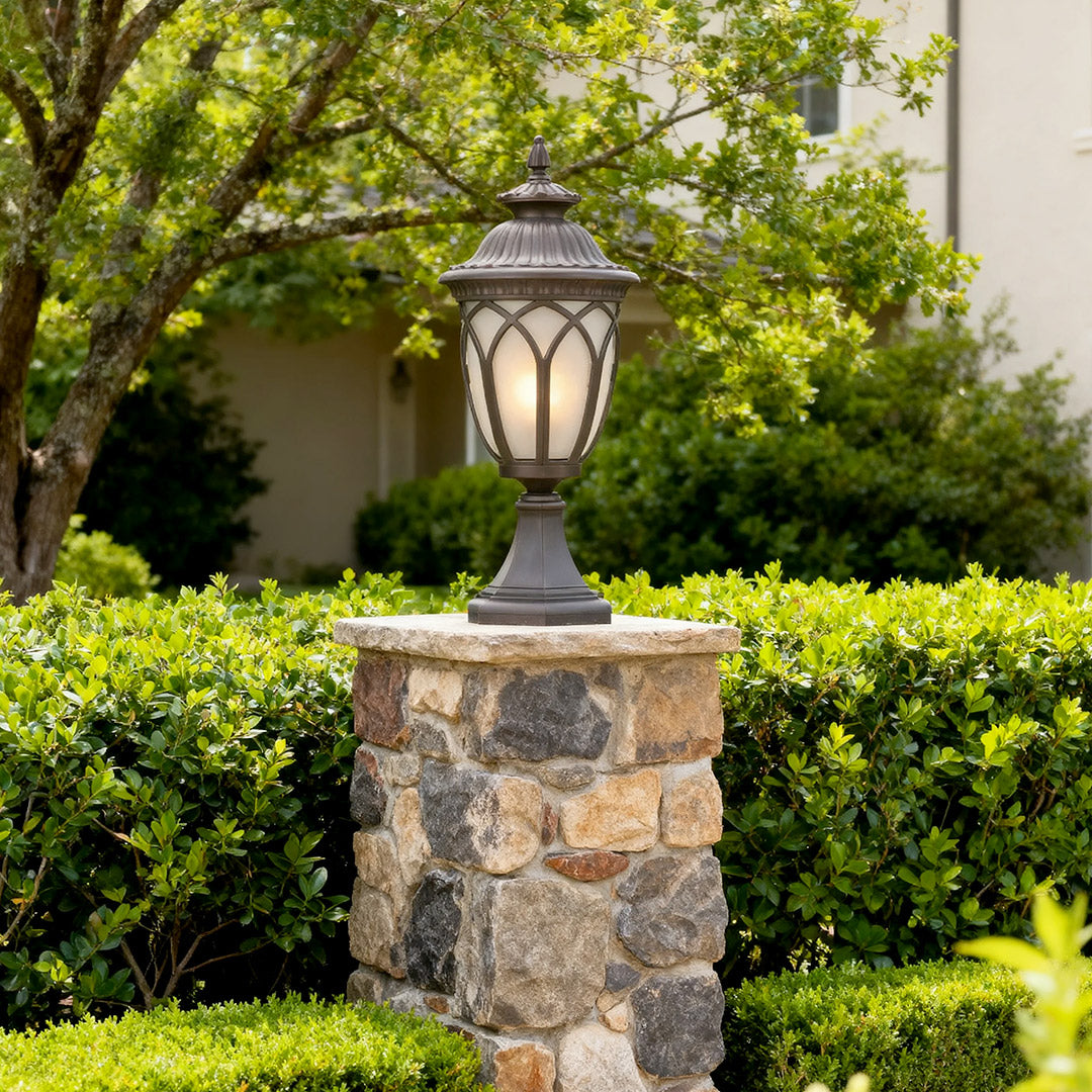 Vintage-style garden pillar light in a lush garden, warm and inviting outdoor lighting