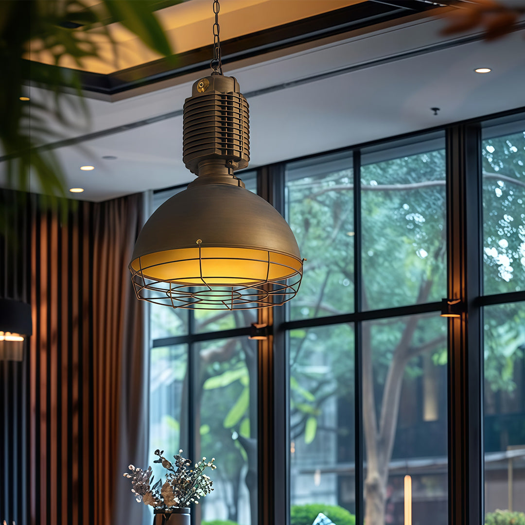 Vintage industrial pendant lighting illuminating modern dining room with large windows and natural garden views