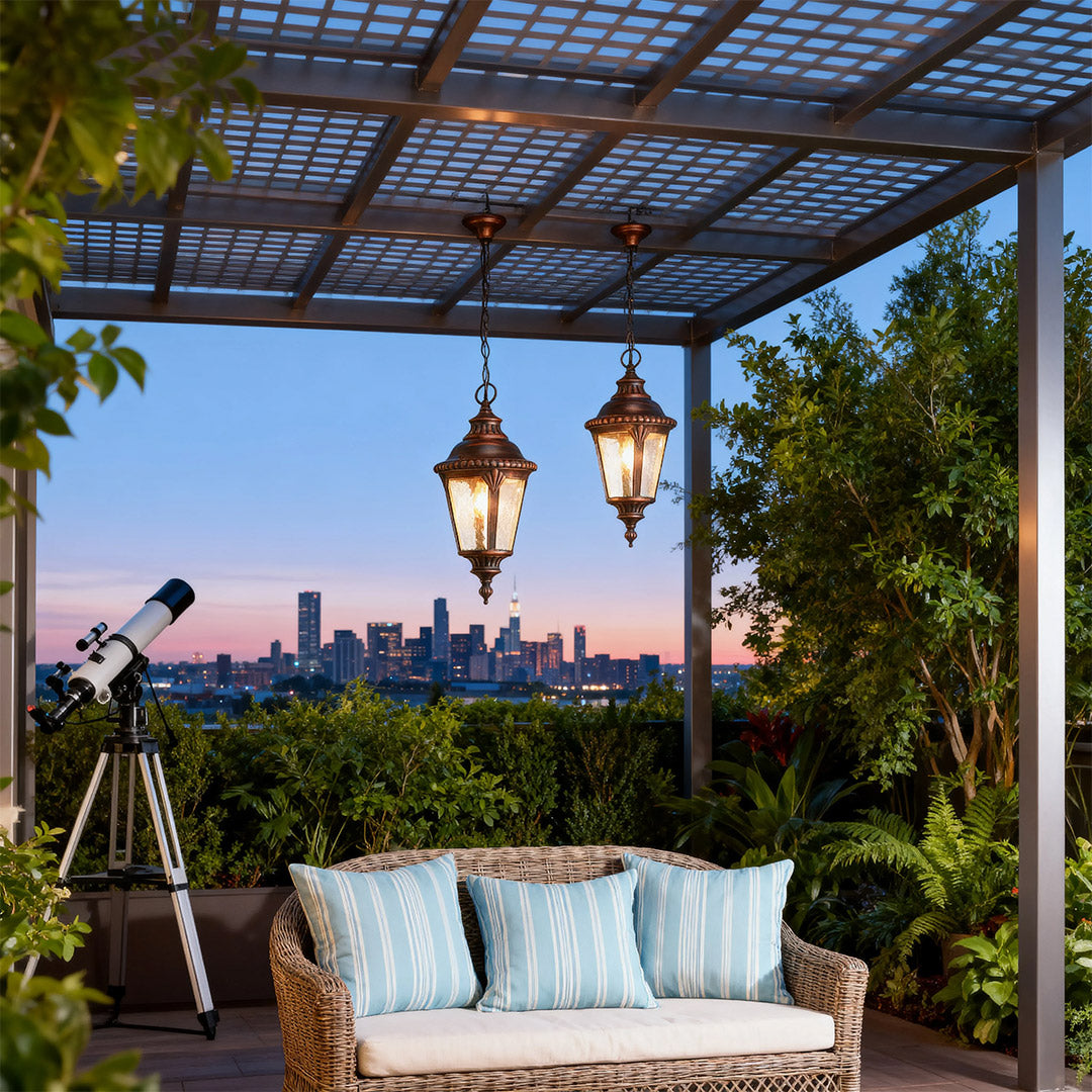 Vintage industrial pendant lights brightening covered patio with wicker swing at twilight blue hour