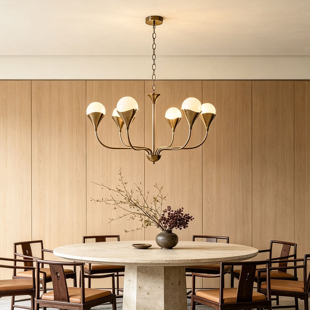 Vintage Italian chandelier suspended above a round dining table in a bright neutral interior.