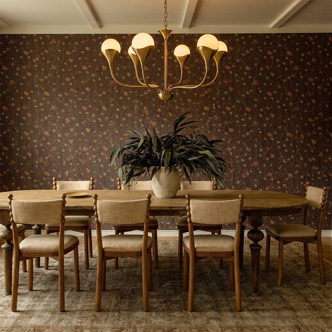 Vintage Italian chandelier above a wooden dining table in a warm traditional dining room.