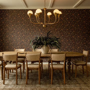 Vintage Italian chandelier above a wooden dining table in a warm traditional dining room.