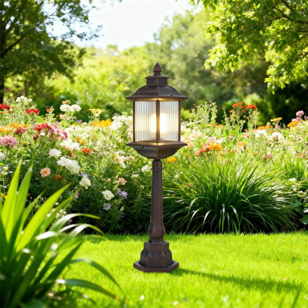 Vintage-inspired LED post light with ornate lantern head brightening garden path among lush greenery
