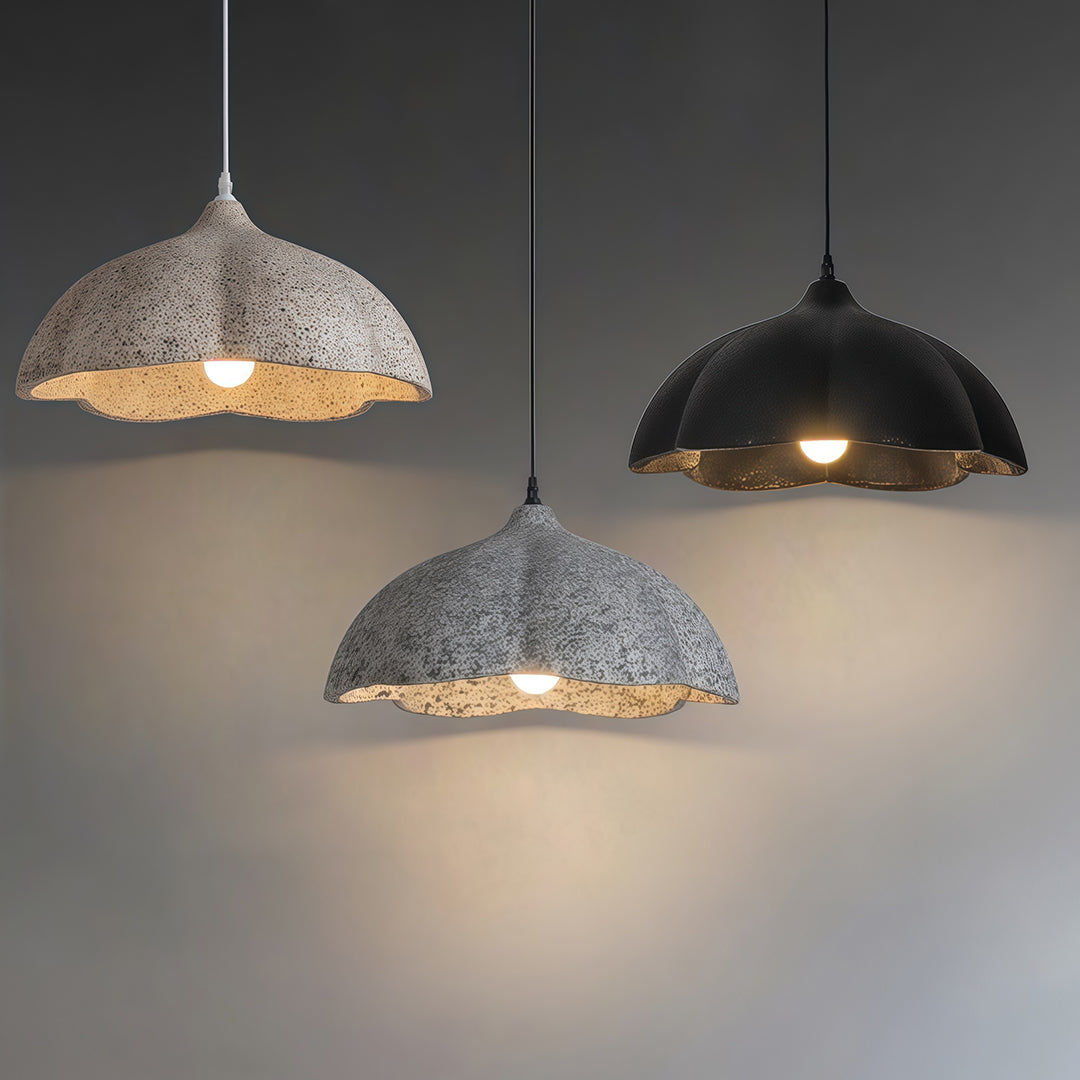 Vintage metal pendant light in gray and black tones creating soft ambient glow in minimalist interior.