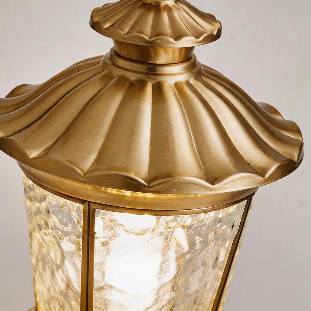 Vintage outdoor lantern with antique brass roof and decorative finial detail