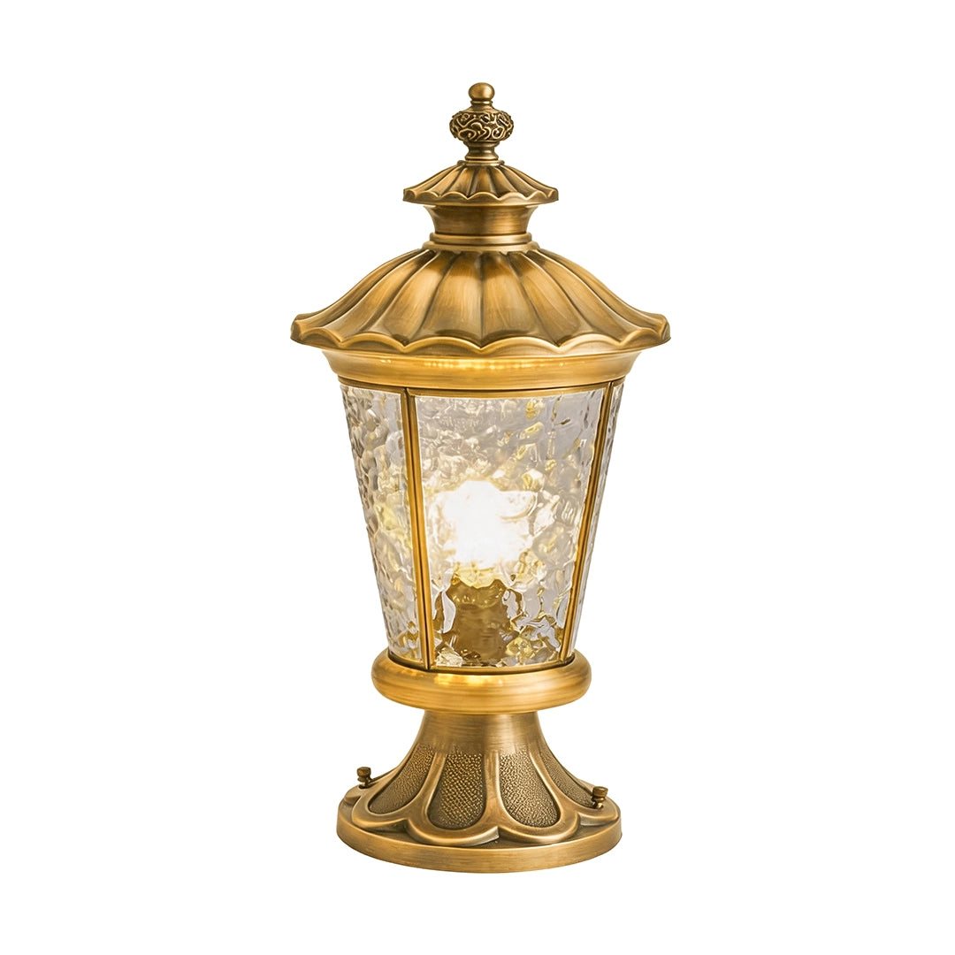 Vintage outdoor pillar lantern with ornate bronze base and warm textured glass