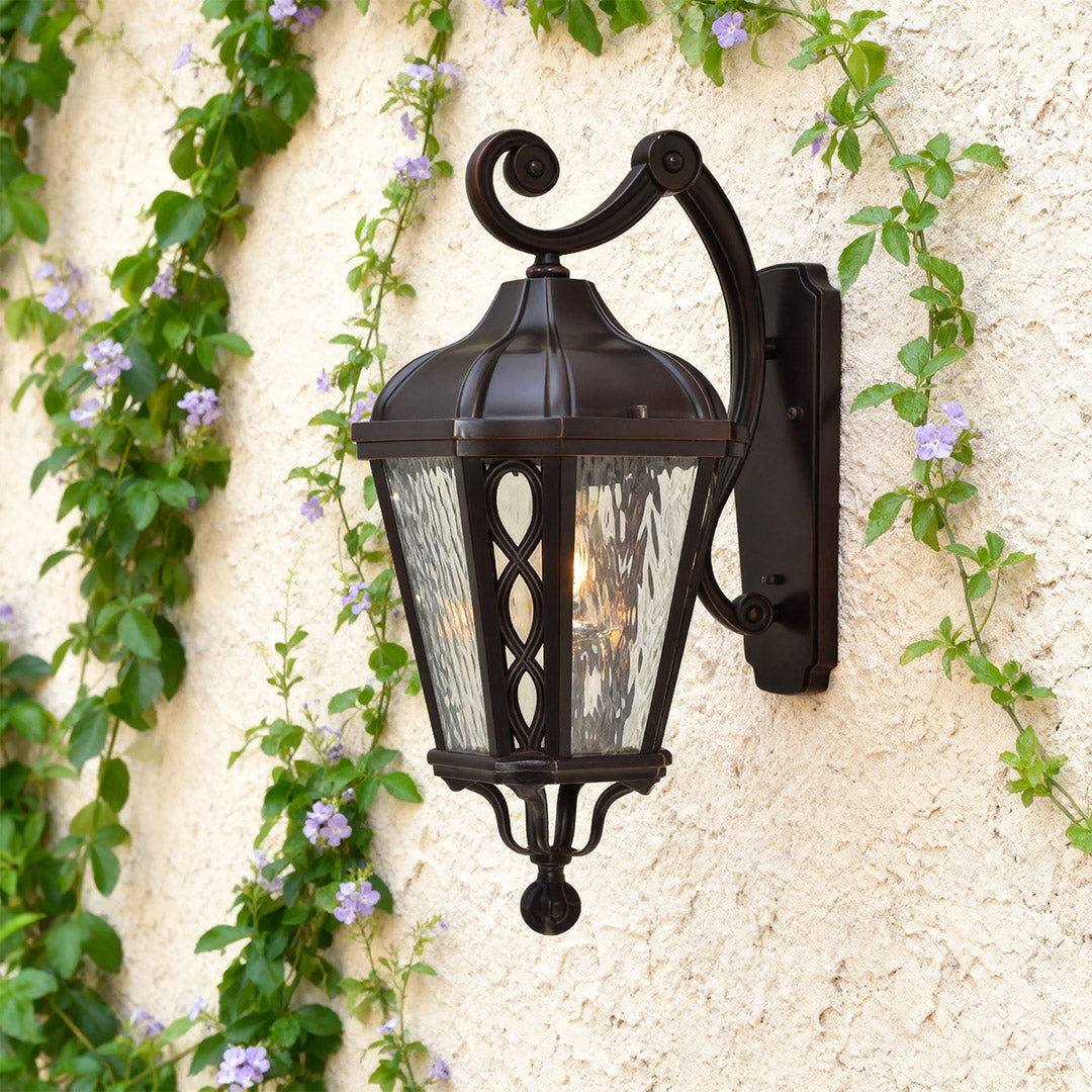 Vintage outdoor sconce on a green wall, warm and inviting exterior lighting