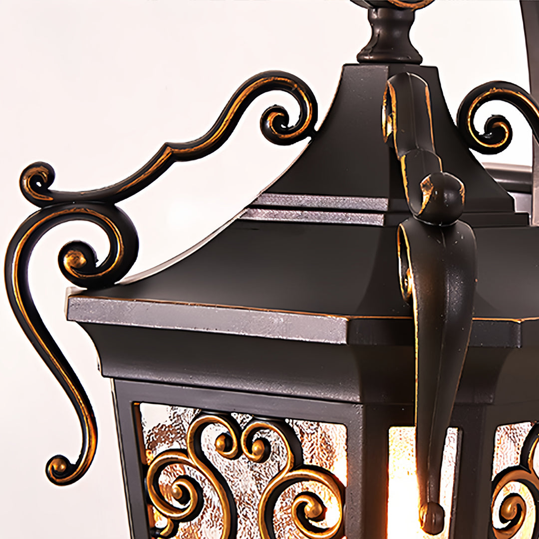 Vintage outdoor wall lantern with warm light illuminating textured exterior wall at night.