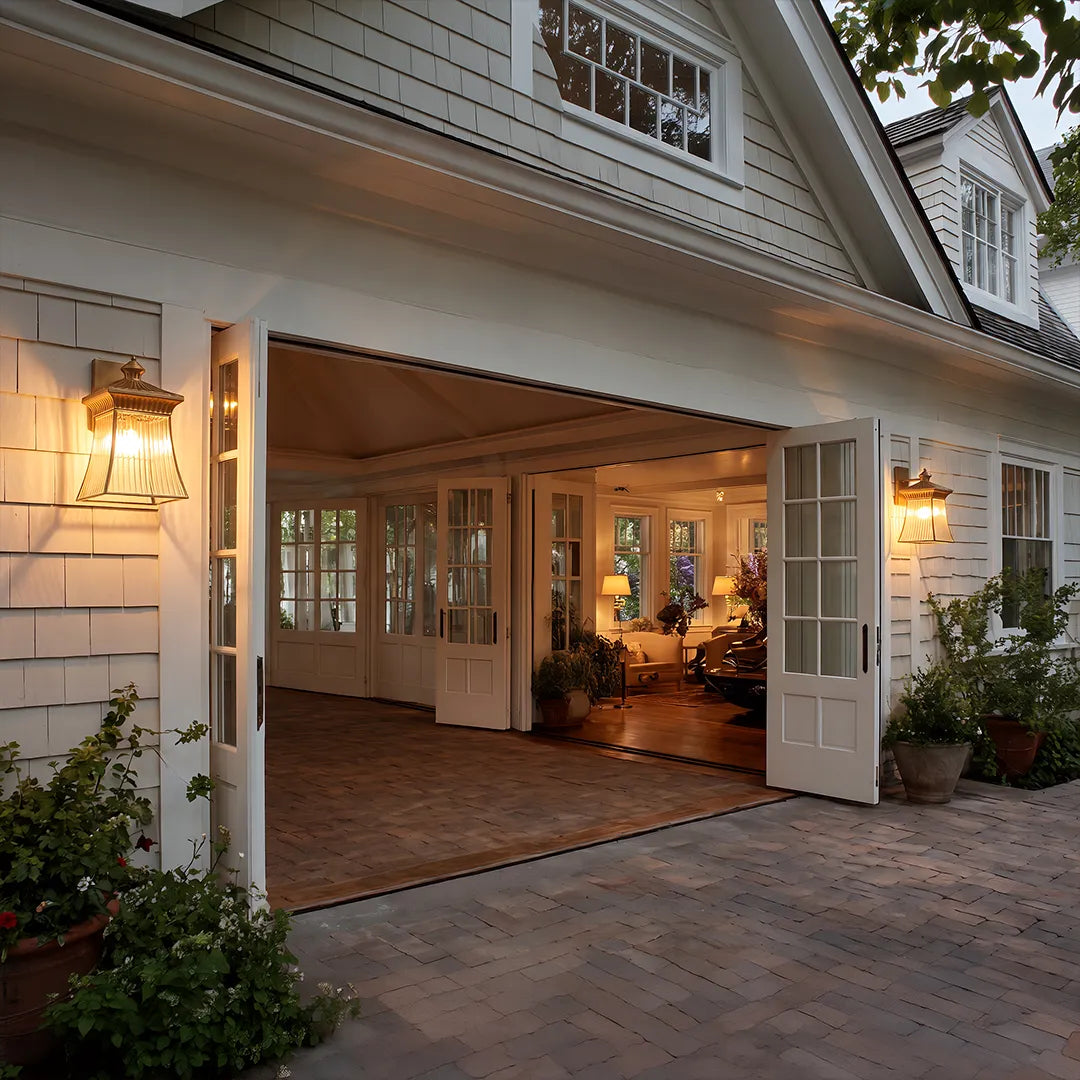 Vintage outdoor wall lanterns with warm glow beside covered home patio