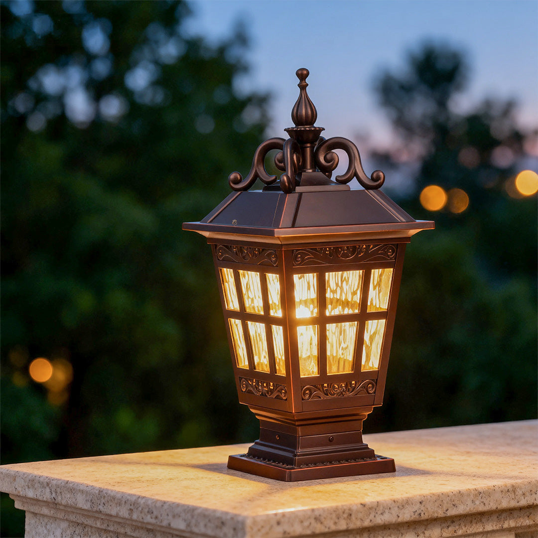 Vintage-style pillar garden light illuminated at dusk, warm and inviting outdoor lighting