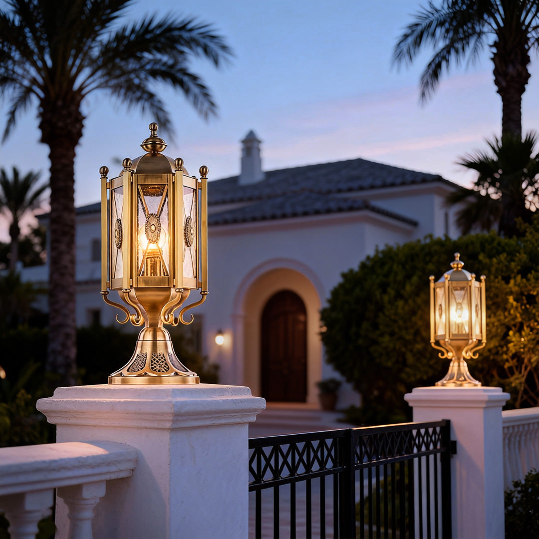 Vintage pillar lights illuminating a grand entrance, creating a warm and inviting ambiance at dusk.