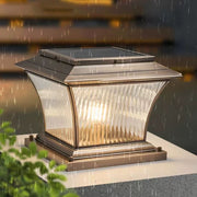 Vintage-style post cap light creating warm ambient lighting in evening garden setting