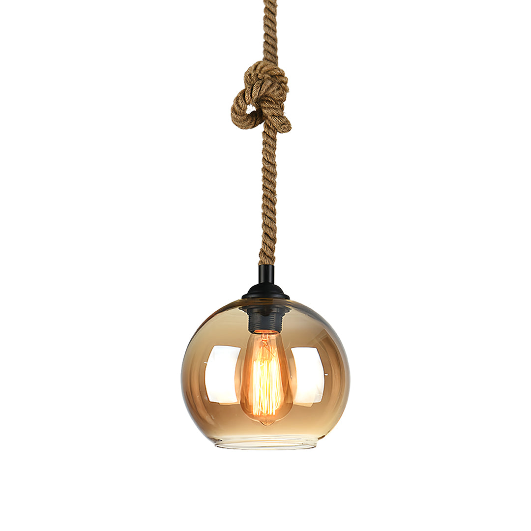 Vintage-style retro glass pendant light with golden amber sphere and black cord suspension.
