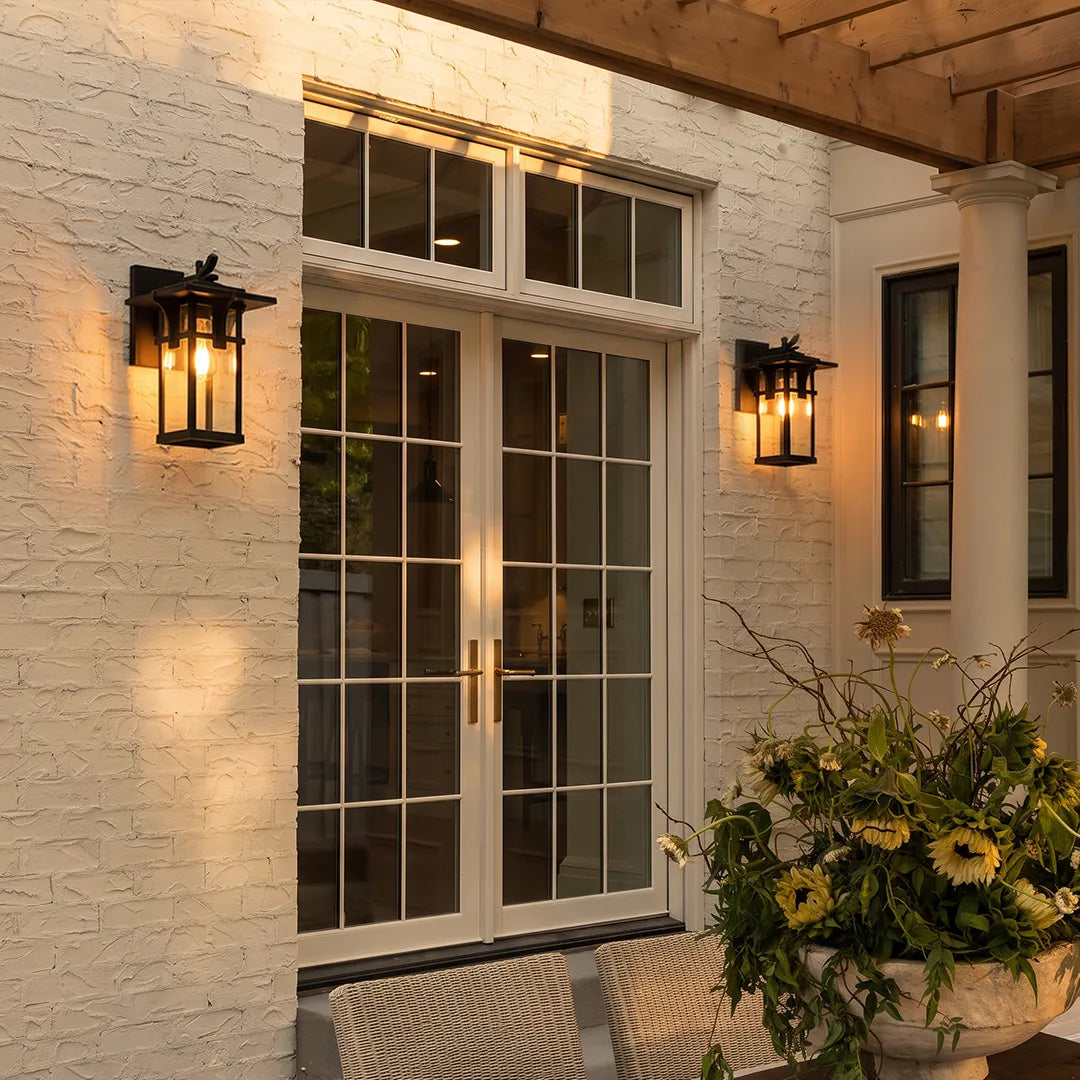 Vintage sconce wall light mounted beside a garage door for classic exterior accent lighting.