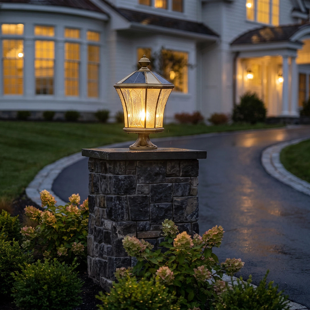 Vintage solar pillar lantern with bronze frame on stone driveway column