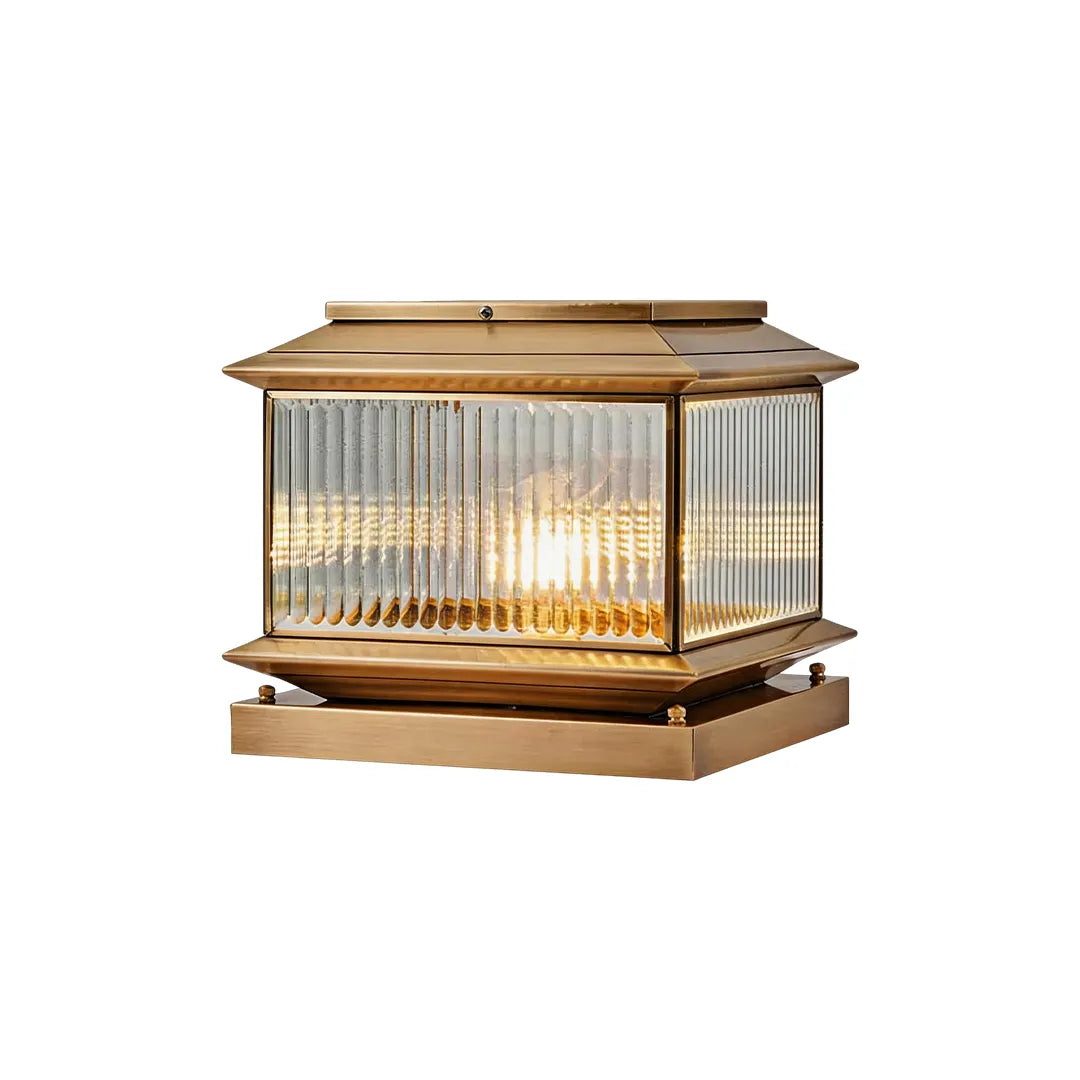 Vintage solar pillar light with antique brass frame ribbed glass and warm lighting